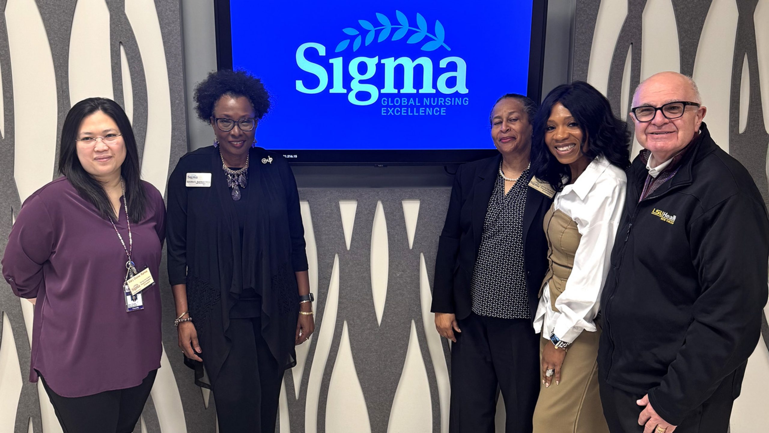 Faculty members are shown at a Six Sigma Research Day.